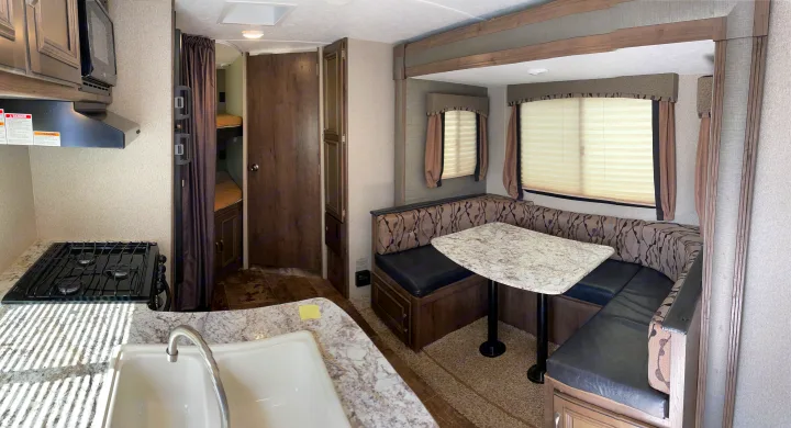 Explore this RV rental's interior: a well-equipped kitchen, comfortable dinette, and cozy bunk beds visible.. Keystone Passport 2400BHWE 2018