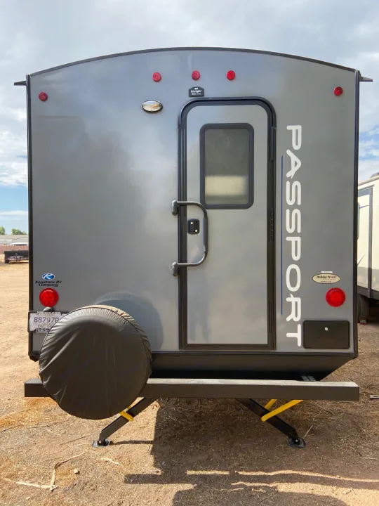 Rear view of a grey Passport RV rental, a perfect camper for your next road trip adventure.. Keystone RV Passport 2021