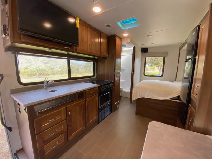 Spacious RV rental interior with full kitchen, comfortable bedroom, and bathroom.. Winnebago Porto 2020