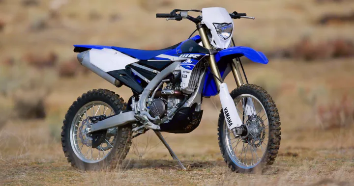 This blue and white Yamaha dirt bike stands ready for off-road action, perfect for an RV rental adventure.. Yamaha WR250F 2015