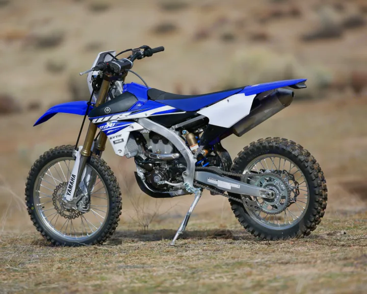 Blue and white Yamaha dirt bike on dirt. Great for off-road fun when paired with an RV rental for trips.. Yamaha WR250F 2015
