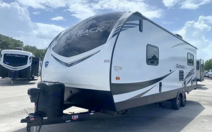 This sleek white Outback Ultra-Lite travel trailer is perfect for your next RV rental. See its spacious design and dual axles for easy towing.. Keystone Outback Ultra-Lite 2021