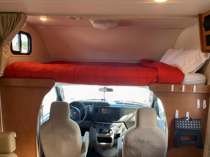 Overhead king sized bed above cockpit. Detachable ladder is used to climb up and down from the bed.. Winnebago Minnie Winnie 2017