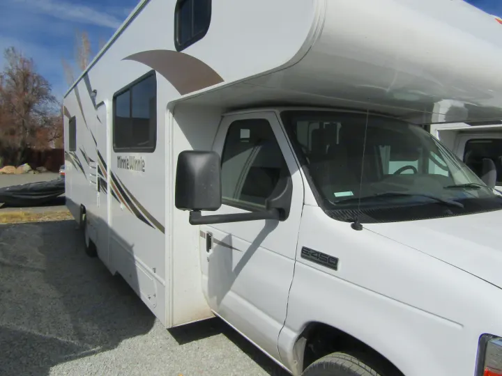 White Minnie Winnie Class C RV rental parked on gravel.. Winnebago Minnie Winnie 2020