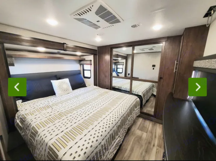 Spacious and modern RV rental bedroom with comfortable bed, mirrored closet, and ample storage. Perfect for travel.. KZ Recreational Vehicles Durango 2021