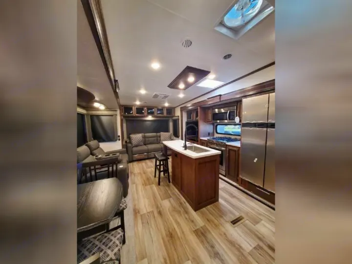 Spacious RV rental interior with modern kitchen, living area, and dining space. Perfect for your next adventure.. KZ Recreational Vehicles Durango 2021