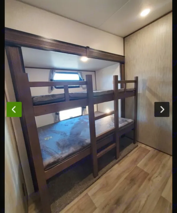 RV rental interior with two dark wood bunk beds and mattresses, ready for sleeping. Ideal for families on the go.. KZ Recreational Vehicles Durango 2021