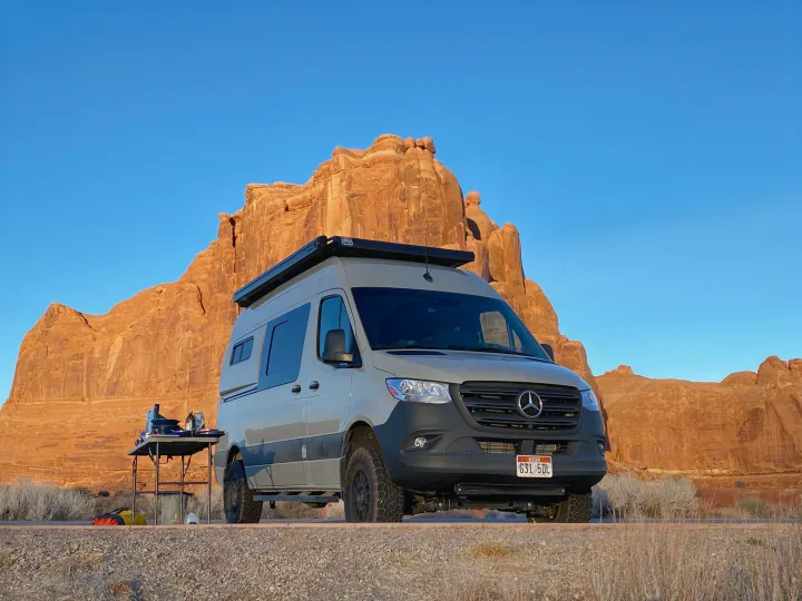 Your next RV rental: a Mercedes Sprinter camper van enjoying a scenic desert campsite in Utah. Perfect for outdoor cooking.. Mercedes-Benz Sprinter 2020