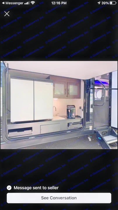 Explore this RV rental's outdoor kitchen, featuring a double-door fridge, sink, cabinets, and appliances for convenient use.. Forest River Grey Wolf 29te 2021