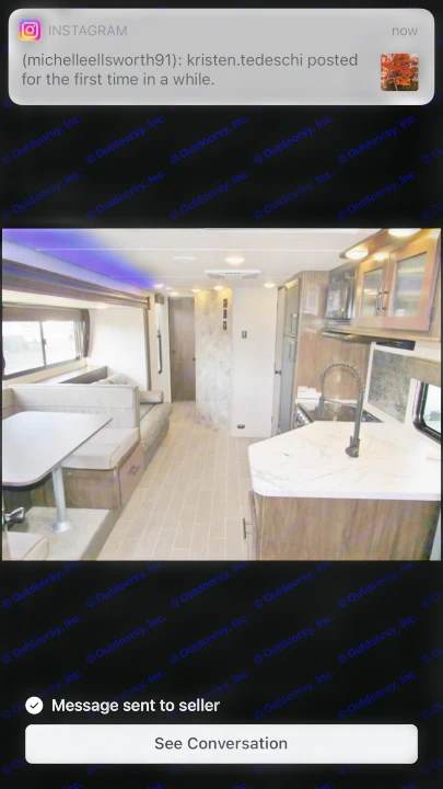 Interior view of a sleek RV rental, showcasing a functional kitchen with a marble counter, dinette, and spacious living area.. Forest River Grey Wolf 29te 2021