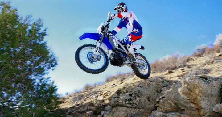 Adventurous dirt bike jump over rocky terrain. An RV rental is perfect for accessing outdoor off-road thrills.. Yamaha WR250F 2015
