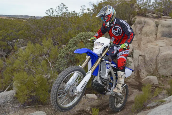 An RV rental trip leads this rider and Yamaha dirt bike to rugged off-road trails, enjoying an outdoor adventure.. Yamaha WR250F 2015