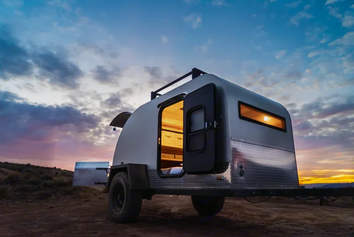 Cozy teardrop trailer rv rental illuminated at sunset, ready for camping in the desert. Perfect for outdoor travel.. PINNACLE Pinnacle Summit 2020