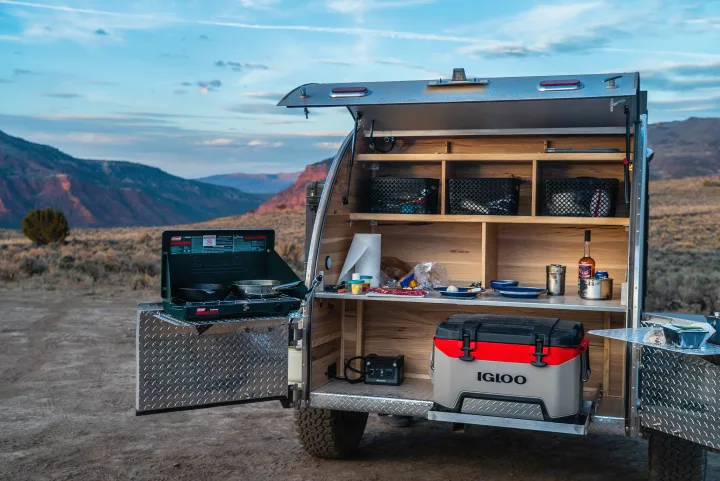 This rv rental teardrop camper offers an outdoor kitchen with stove, cooler, and shelving, perfect for scenic camping trips.. PINNACLE Pinnacle Summit 2020