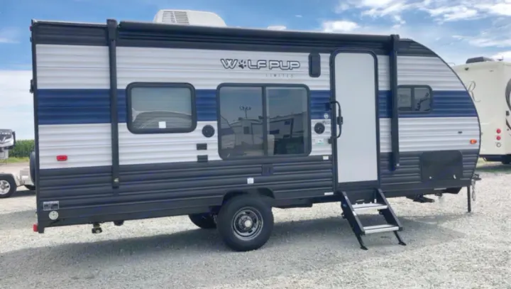 Blue & grey Wolf Pup travel trailer, great for RV rental camping adventures. Features awning, windows & door.. Forest River Wolf Pup 2021