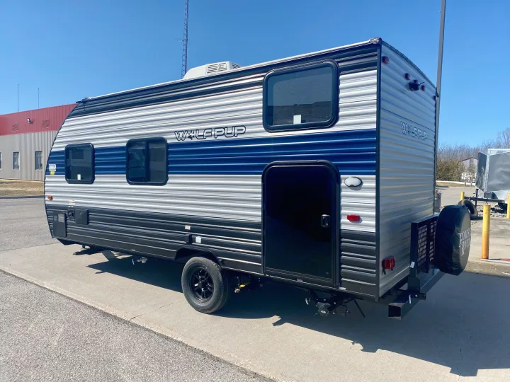 Side view of a modern gray & blue 'Wolf Pup' travel trailer, featuring windows & a side door, perfect for an RV rental.. Forest River Wolf Pup 2021