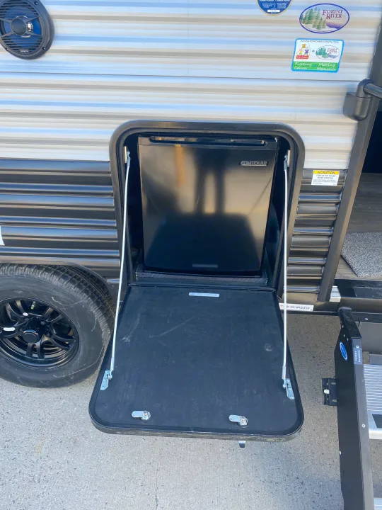 RV rental with a convenient outdoor kitchen: a Contoure mini-fridge and a sturdy fold-down counter for camping.. Forest River Wolf Pup 2021