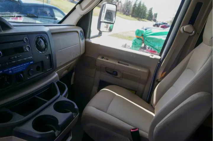 RV rental interior: dash, steering wheel glimpse, passenger seat, cup holders. Ready for a comfy road trip adventure.. Thor Motor Coach Four Winds Majestic 2013