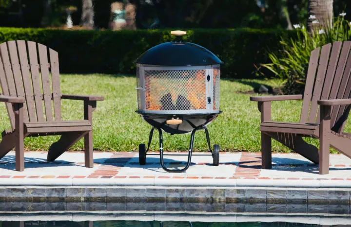 Enjoy cozy evenings by the pool. This fire pit and Adirondack chairs offer perfect outdoor relaxation, ideal after an RV rental adventure.. Keystone Hideout 2016