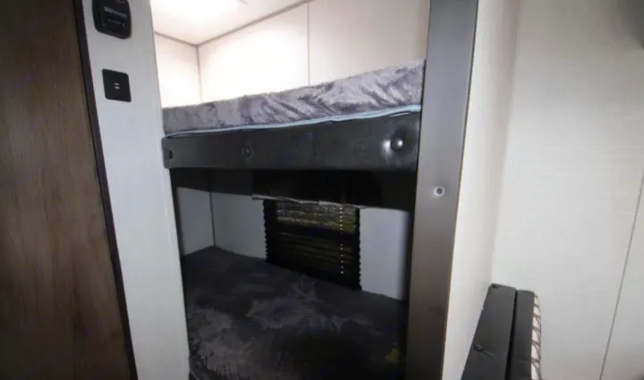Cozy bunk beds with comfy mattresses and USB ports, perfect for your next RV rental family adventure on the road.. Prime Time Avenger 2021