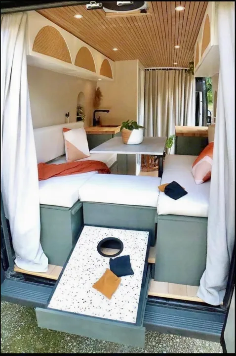 This RV rental camper van boasts a stylish interior with cozy seating, kitchen, and a pull-out cornhole game at the rear.. Other Other 2015