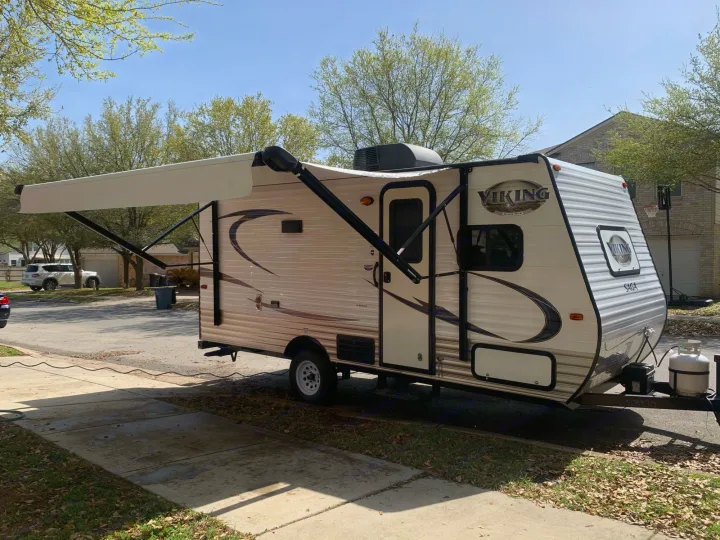 Curbside with power awning extended.. Forest River Viking 2018