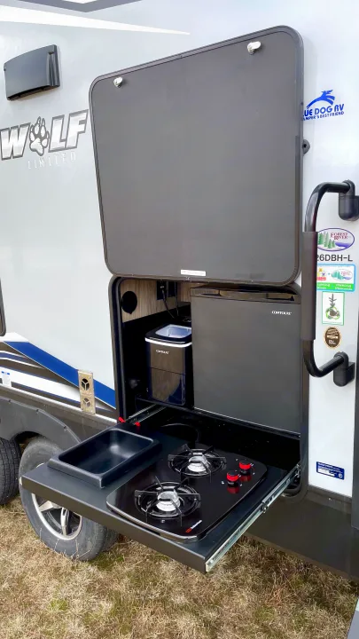 This RV rental features an outdoor kitchen with a fridge, ice maker, pull-out two-burner stove, and sink for easy camping.. Forest River Cherokee 2021