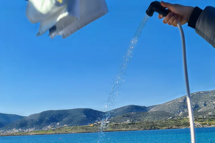 Enjoying an outdoor shower from an RV rental, with a stunning sea view and mountains.. Volkswagen T6 2020