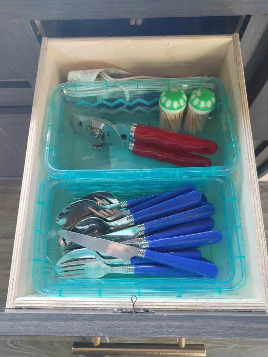 RV rental: Organized drawer with two clear bins holding a can opener, toothpicks, and blue silverware.. Other Attitude 2021