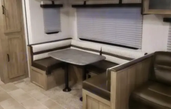 U shaped dinette with storage. Also folds down to bed. Forest River Palomino Puma XLE Lite 2021