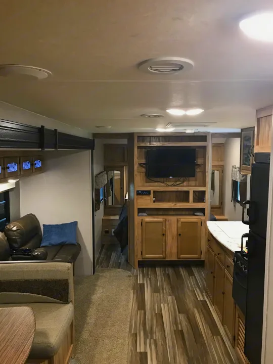 Inside this spacious RV rental: a cozy living room, dining area, well-equipped kitchen, and comfortable bedroom.. Coachmen Freedom Express 2018