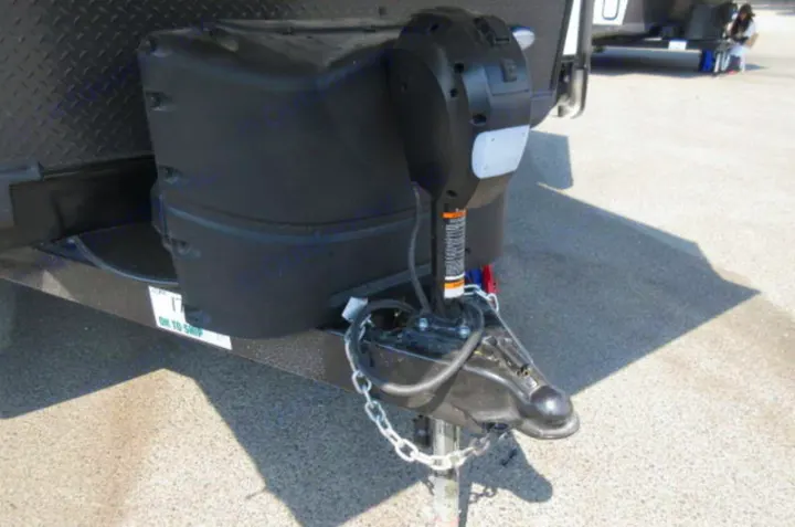 RV rental trailer: Close-up of the front, featuring the propane tank cover, electric tongue jack, and hitch.. Forest River Rockwood Roo 2021