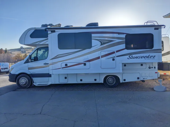 White Sunseeker RV rental, a Forest River motorhome, parked and ready for your next travel adventure.. Forest River Sunseeker 2016