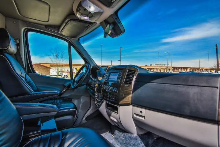 Inside this RV rental, comfortable black leather seats and a modern dashboard offer a bright view of the blue sky and road ahead.. Mercedes Sprinter 2016
