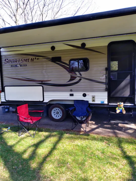 RV rental with awning, LED lights, camping chairs, and a teddy bear on the steps. Perfect for an outdoor adventure.. KZ Other 2017