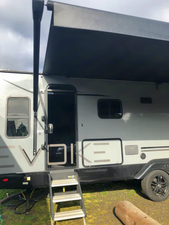 Back entrance with outdoor fridge and stove. outdoor shower as well in small grey box. Travel Lite Other 2020