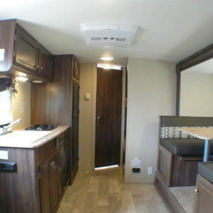 RV rental interior features a kitchen with stove, microwave, and fridge, plus a dinette and living area.. Coachmen nano 2017