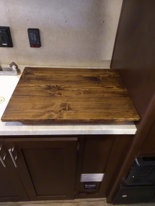 RV rental: Dark wood counter extension, cabinetry, and utility controls in kitchen.. Forest River Cherokee Wolf Pup 2017