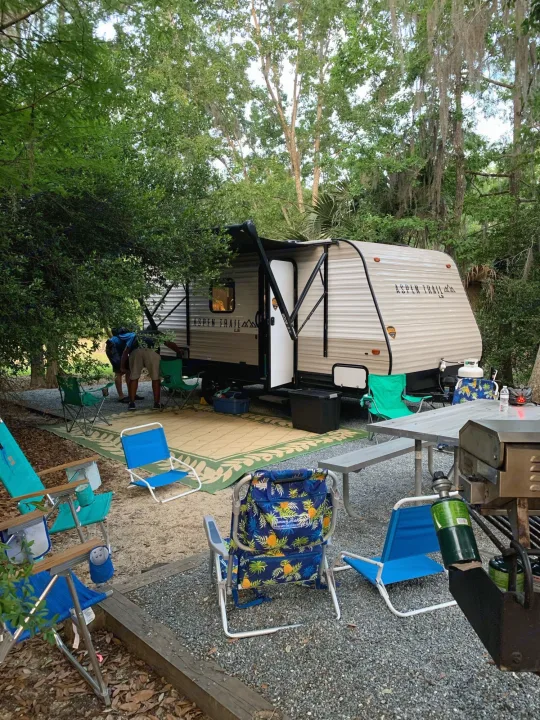 Our RV rental campsite is perfectly set for adventure! A travel trailer, comfy chairs, and grill await outdoor enjoyment.. Aspen Other 2021