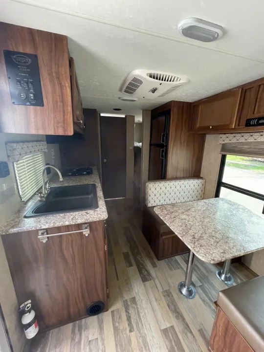 Cozy RV rental interior featuring a compact kitchen, comfortable dinette, and ample storage, perfect for your next adventure.. Viking 21BH 2018