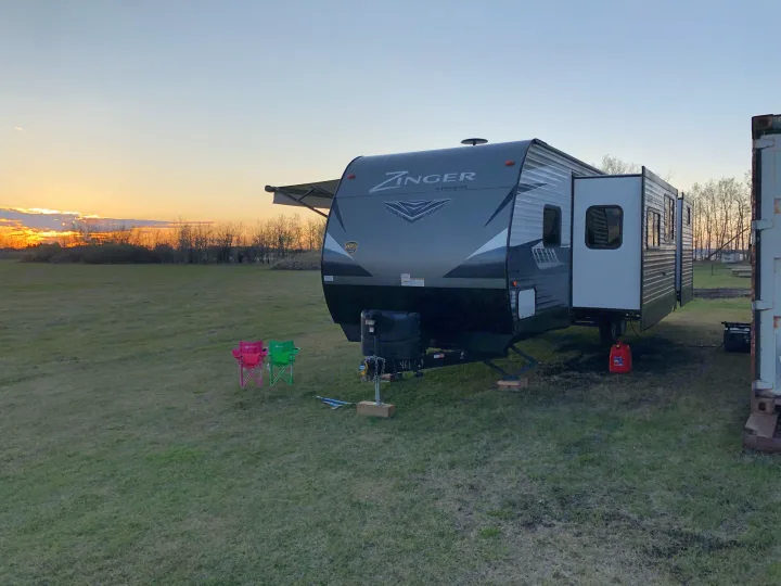 Head on view with awning and both slides extended. Crossroads Zinger 2018