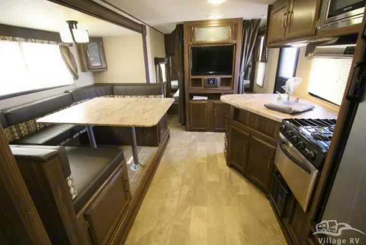 Spacious RV rental interior featuring a comfortable U-shaped dinette, a well-equipped kitchen, and an entertainment center.. Coachmen Other 2019