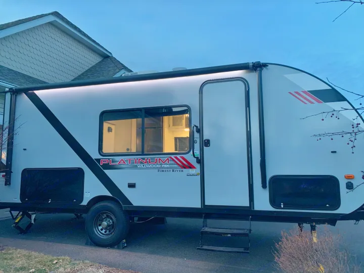 large awning, exterior LED, electric outlets, rear storage with mini fridge. Forest River Wildwood 2021