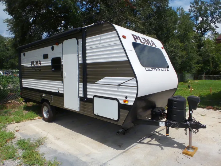 New Puma Ultra Lite travel trailer RV rental, parked on concrete. Perfect for outdoor adventures.. Palomino 18SSX 2019