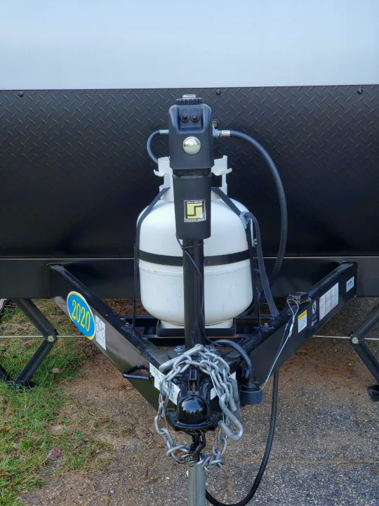 RV rental trailer's 2020 front hitch with dual propane tanks, electric tongue jack, and safety chains.. Forest River Salem 2020