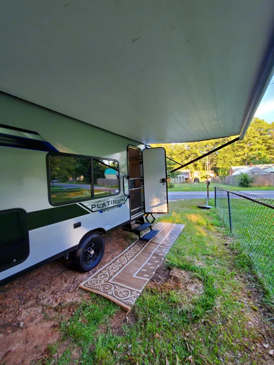 This travel trailer RV rental offers an extended awning, outdoor rug, and steps for a comfortable setup.. Forest River Salem 2020