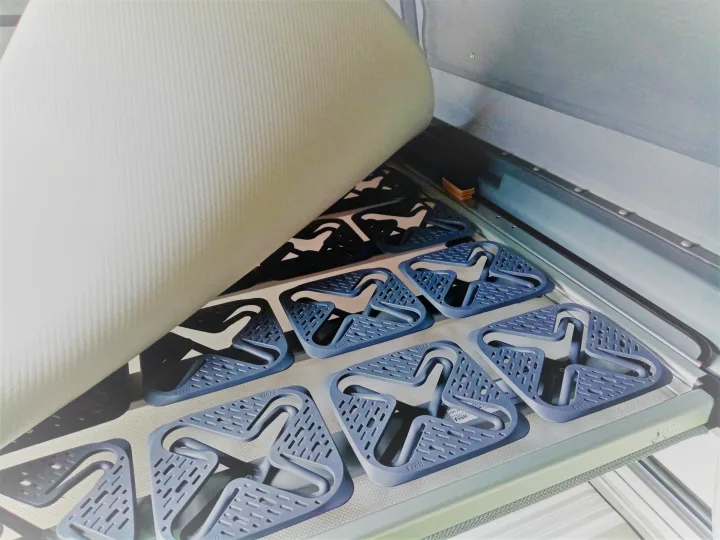 RV rental bed system: Mattress lifted to reveal Froli modular support elements, ensuring comfortable sleep and ventilation.. Volkswagen Transporter T6 2021