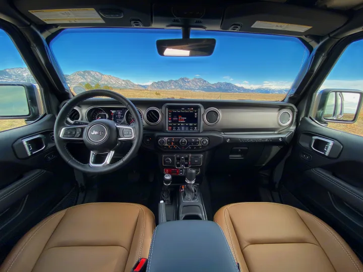 Jeep Wrangler interior with mountain vista, perfect for outdoor travel. More nimble than an rv rental for rugged terrain.. Jeep Wrangler Unlimited 2021