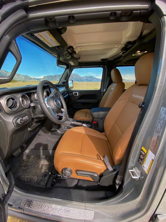 Jeep Wrangler Rubicon's tan interior and mountain view. Ideal for rugged adventure, an exciting alternative to an RV rental.. Jeep Wrangler Unlimited 2021