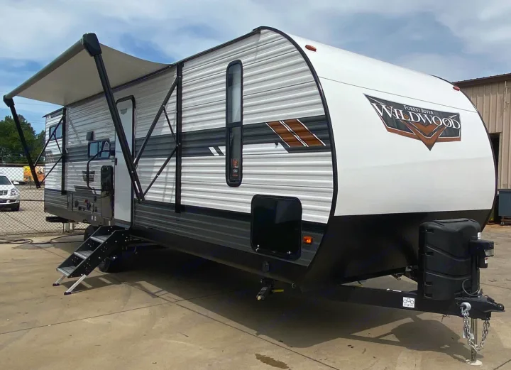 Spacious Forest River Wildwood travel trailer with awning extended, perfect for your next RV rental adventure.. Forest River Wildwood 2021